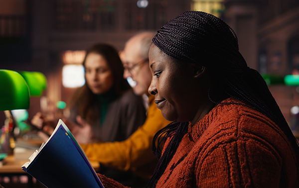 Woman reading in warm dim lighting